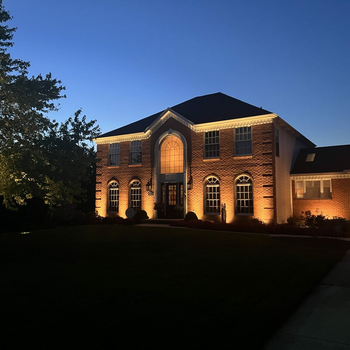 landscape outdoor lighting. uplighting for a large home.